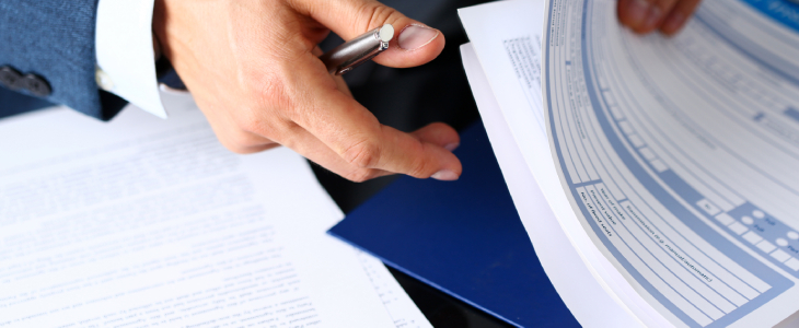 a hand holding some documents