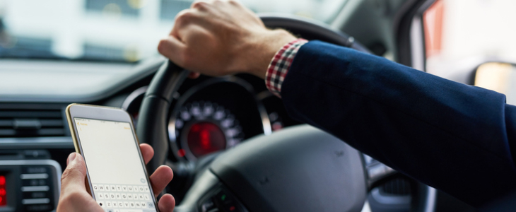 Man using phone while driving