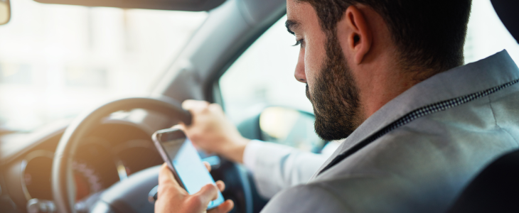 Man driving while on his phone in Los Angeles