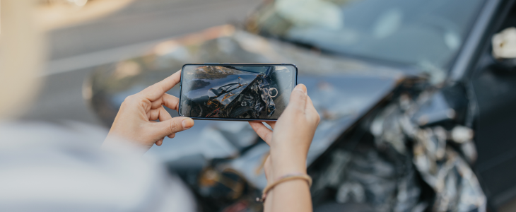 Lady taking picture of her damaged car after a hit-and-run in Los Angeles