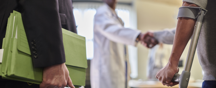 Doctor greeting a personal injury attorney and personal injury victim