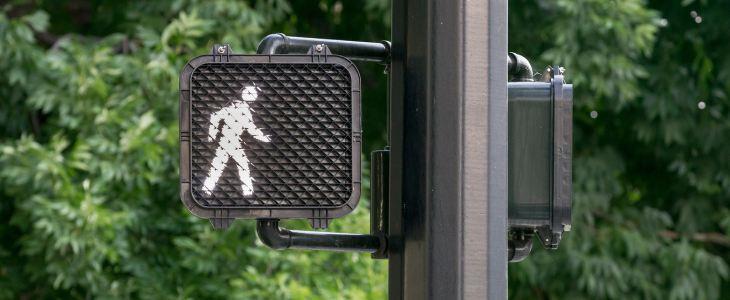 Crosswalk sign saying walk for pedestrians