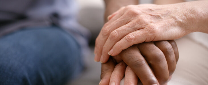 Senior couple holding hands, love and support, trust and care in retirement together. Closeup of elderly, old and diverse people, hand holding and hope, empathy and solidarity, kindness and gratitude