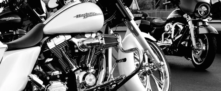 Kansas City, United States – September 24, 2021: A grayscale of a rare white Harley Davidson motorcycle on the road